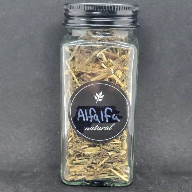 Glass jar filled with dried alfalfa leaves, labeled "Alfalfa" on a black background.